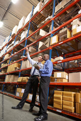 Two Businessmen With Digital Tablet In Warehouse