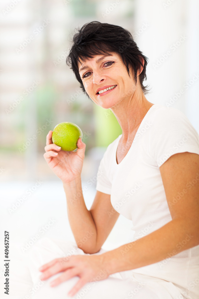 beautiful mature woman holding a fresh green apple beautiful mature woman holding a fresh green apple