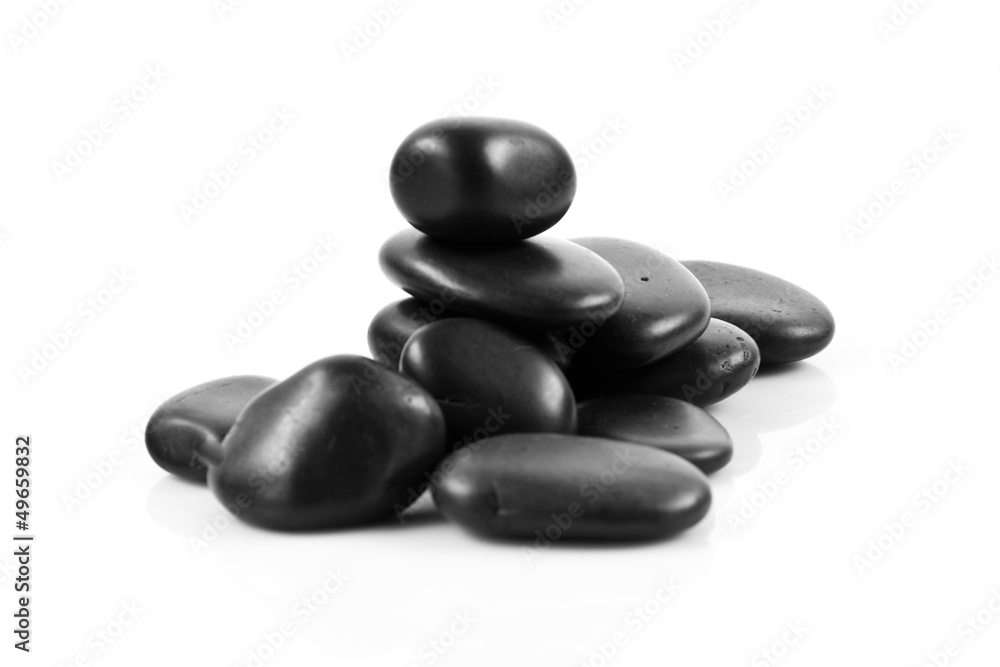 Black massage stones stacked, isolated. Black massage stones stacked, isolated.