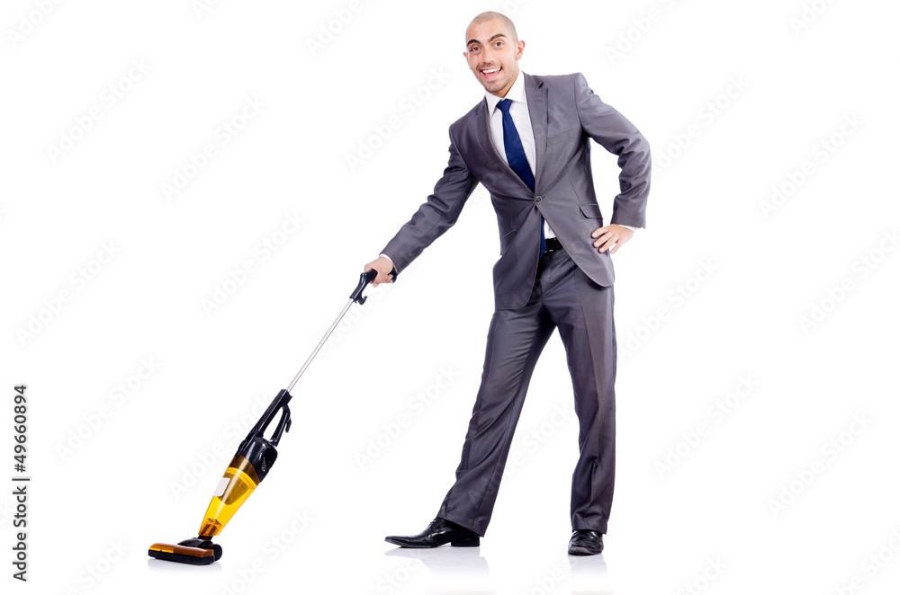Businessman doing vacuum cleaning on white Businessman doing vacuum cleaning on white