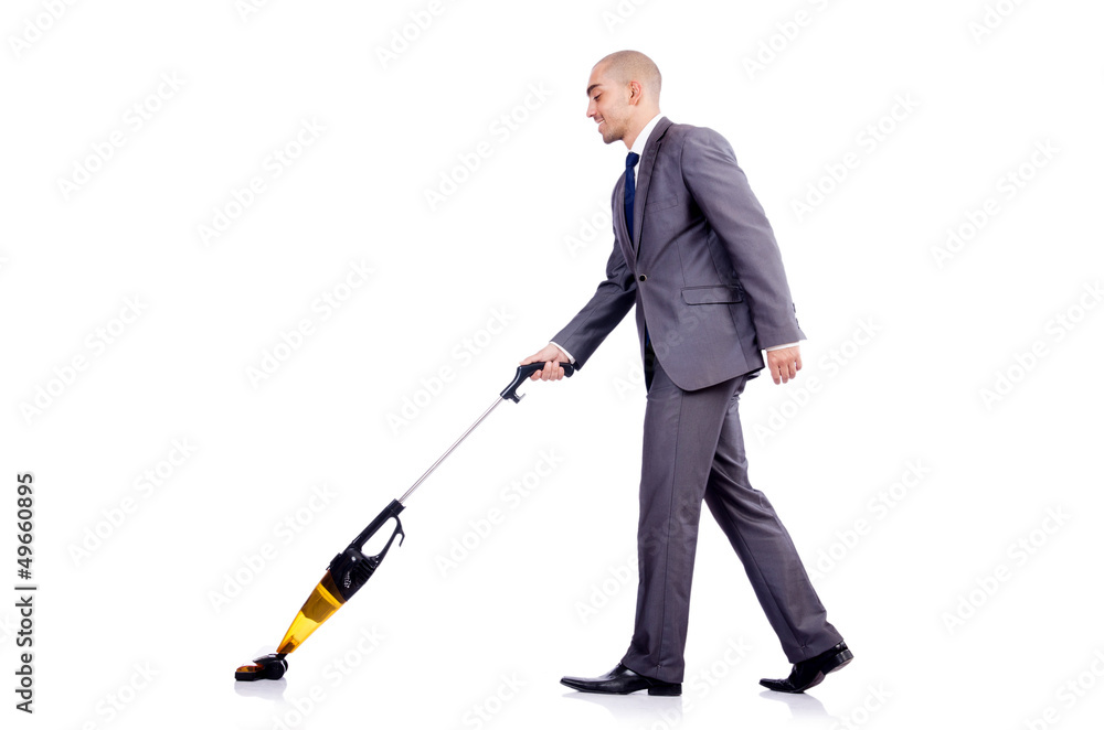 Businessman doing vacuum cleaning on white Businessman doing vacuum cleaning on white