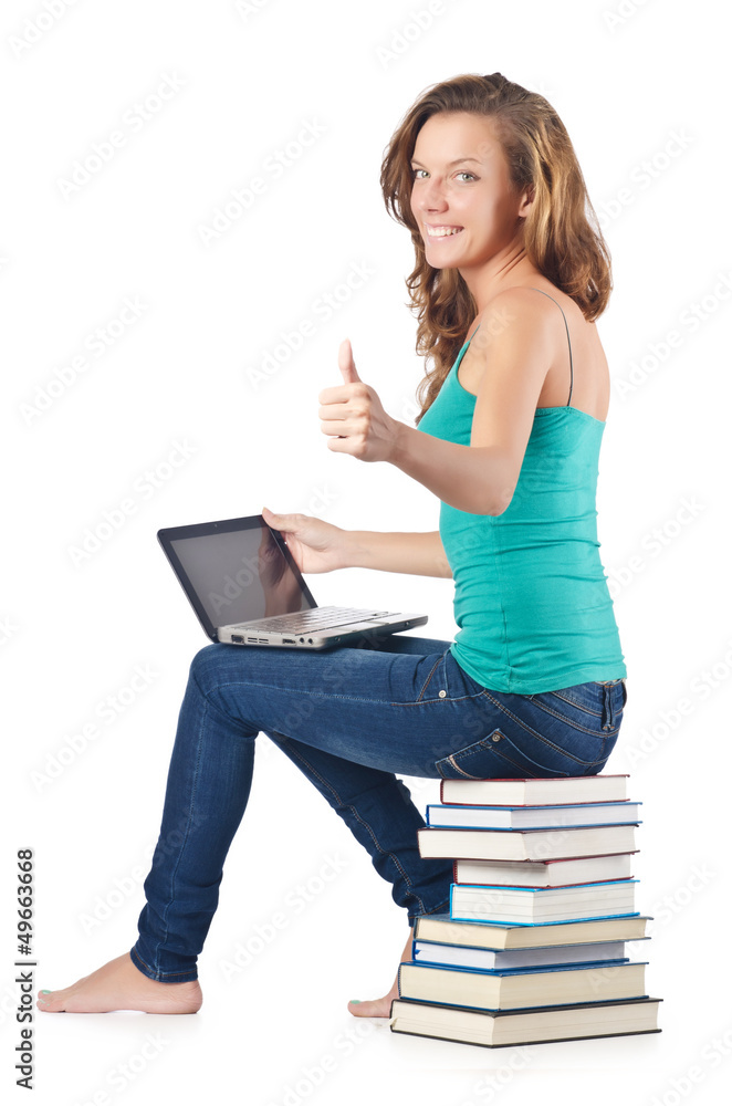 Student with netbook sitting on books Student with netbook sitting on books