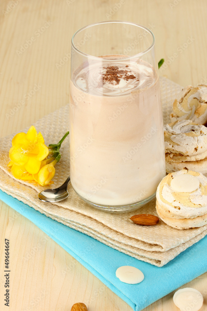Glass of chocolate-cream cocktail on wooden table close-up