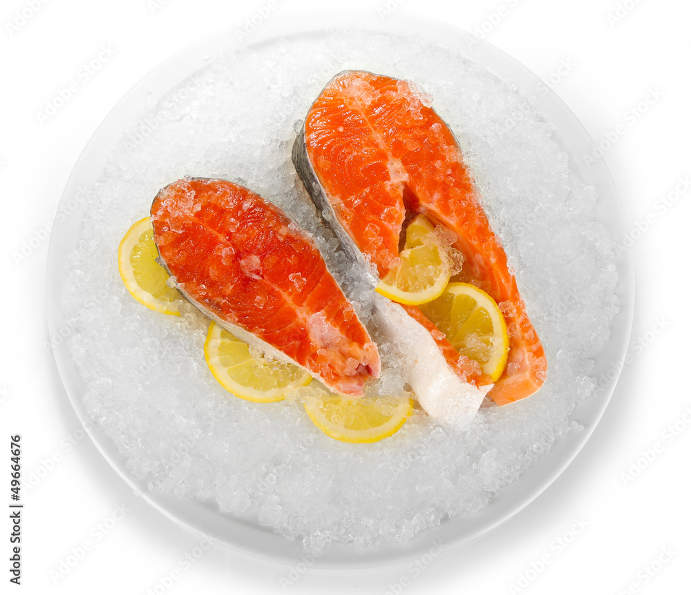 Pieces of red fish on ice in plate isolated on white Pieces of red fish on ice in plate isolated on white