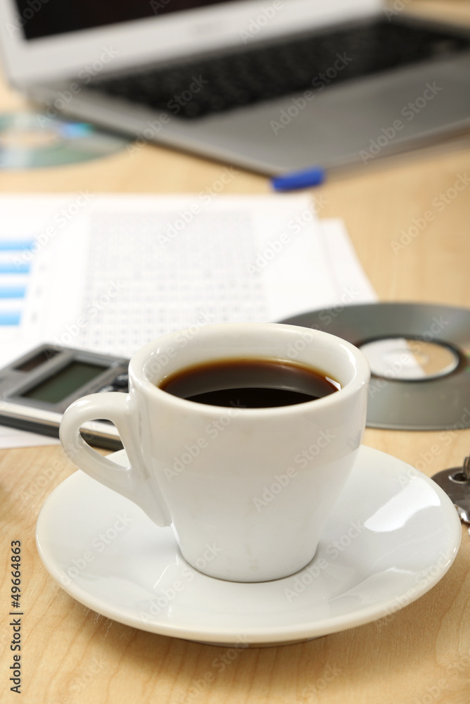 Cup of coffee on office desktop close-up Cup of coffee on office desktop close-up