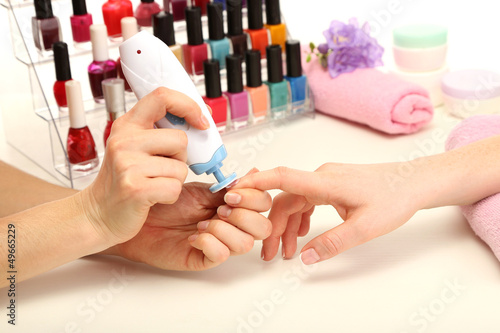 Manicure process in beauty salon, close up
