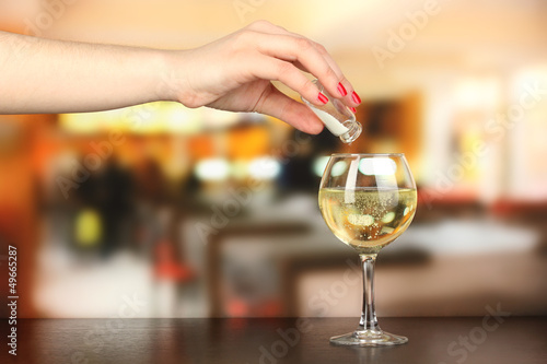 Pour something into glass with drink
