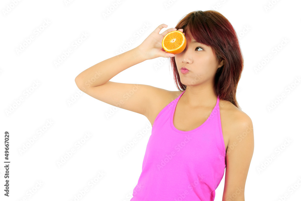 Isolated young asian woman with pieces of orange Isolated young asian woman with pieces of orange