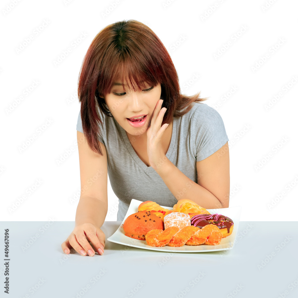 Isolated young asian woman with a donuts on the table Isolated young asian woman with a donuts on the table