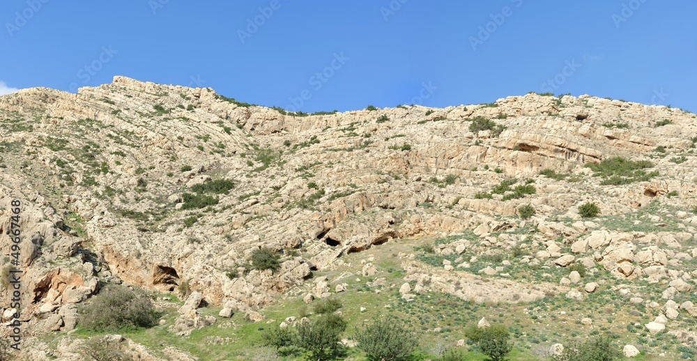 Texture of a layered sedimentary rock under the blue sky