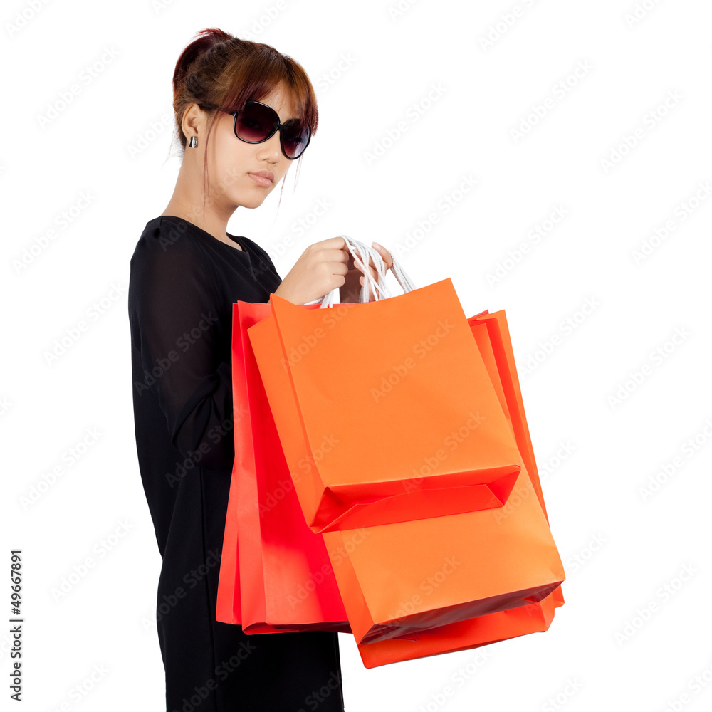 Isolated young asian woman carries shopping bags Isolated young asian woman carries shopping bags