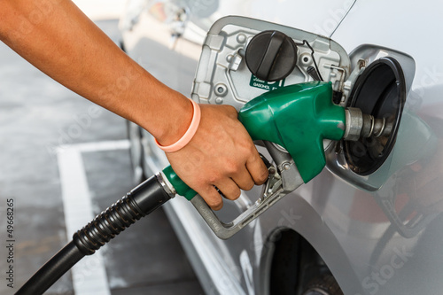 Man refilling the car with fuel on a filling station