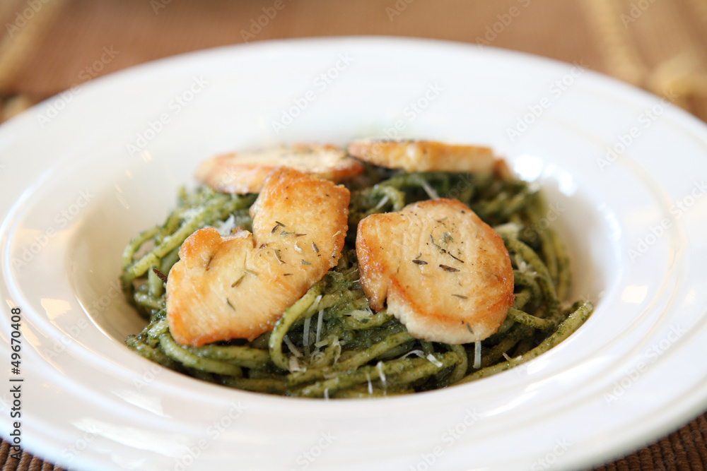 spaghetti with pesto sauce on wood background spaghetti with pesto sauce on wood background