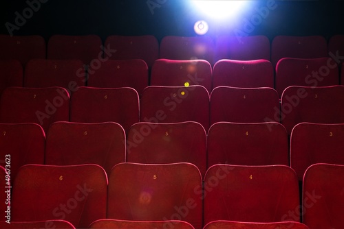 Empty comfortable red seats with numbers in cinema