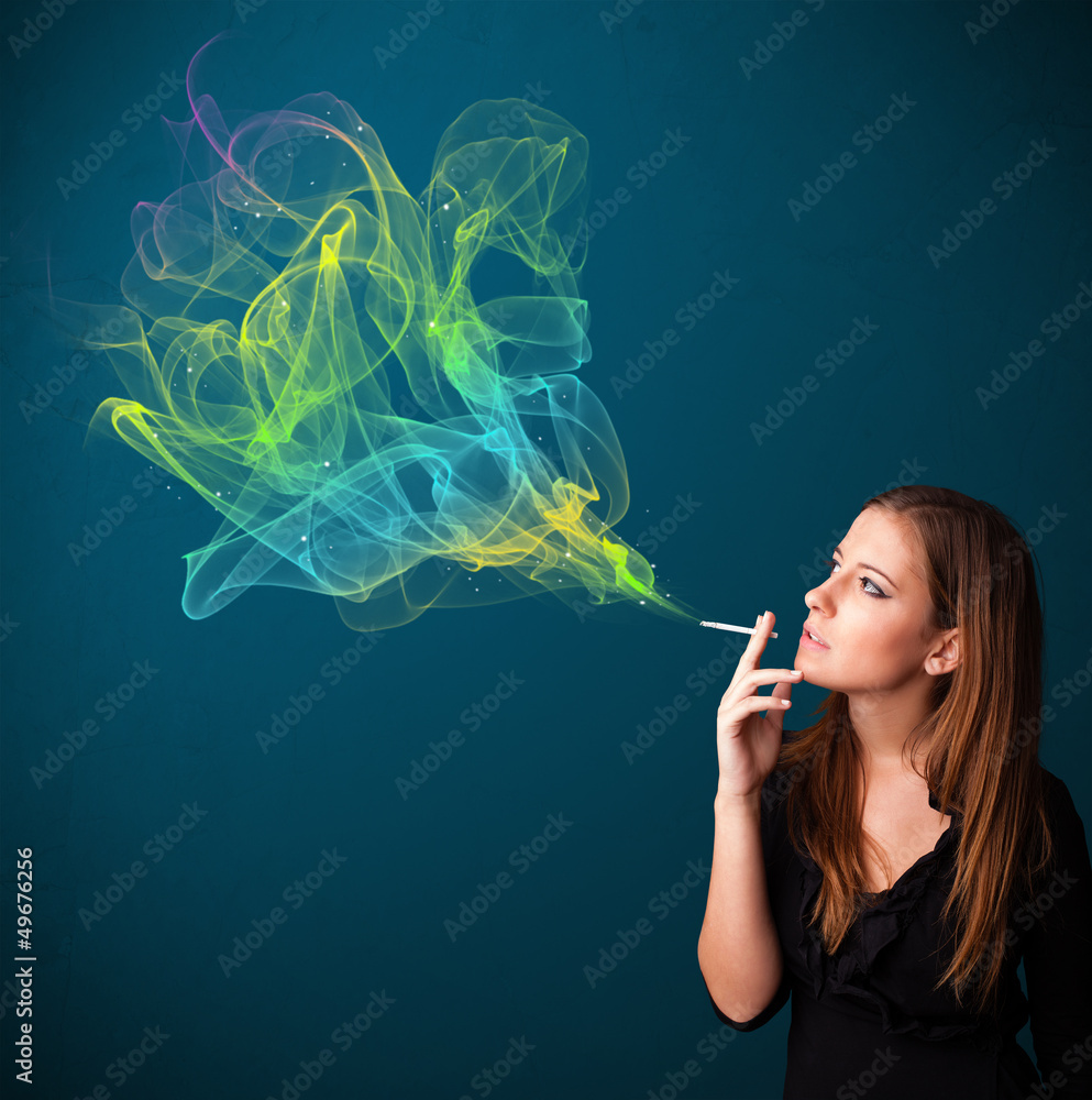 Obraz premium Pretty lady smoking cigarette with colorful smoke