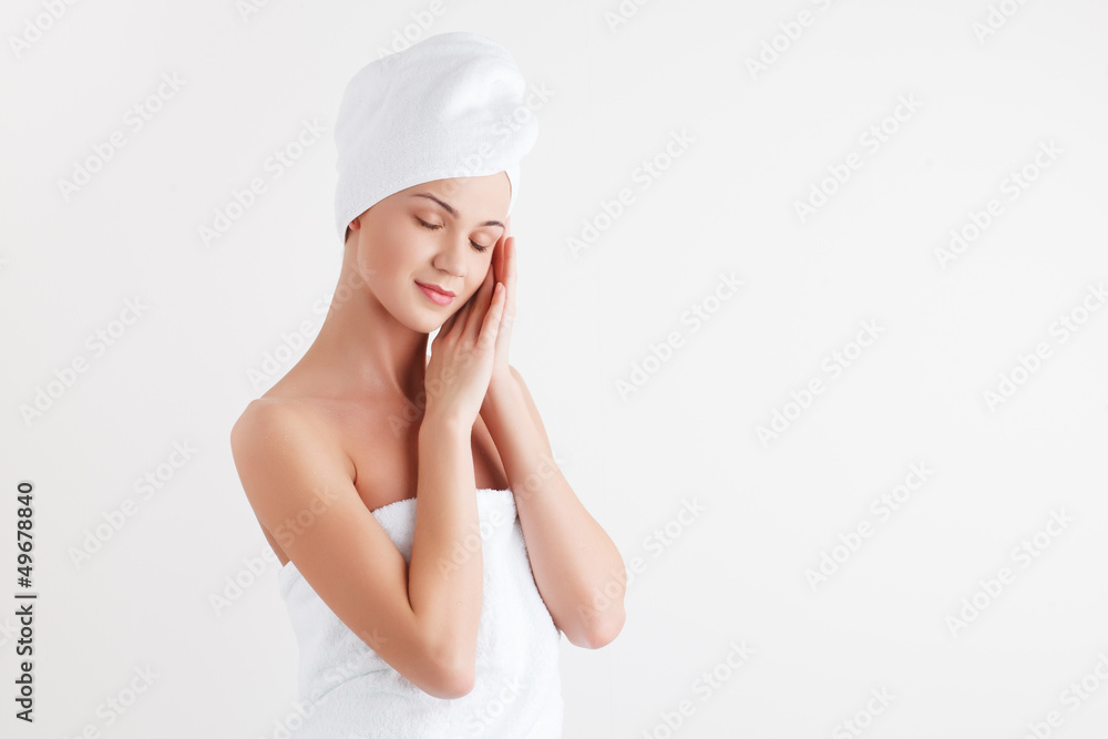 Beautiful blonde female model in bath towel on white background Beautiful blonde female model in bath towel on white background
