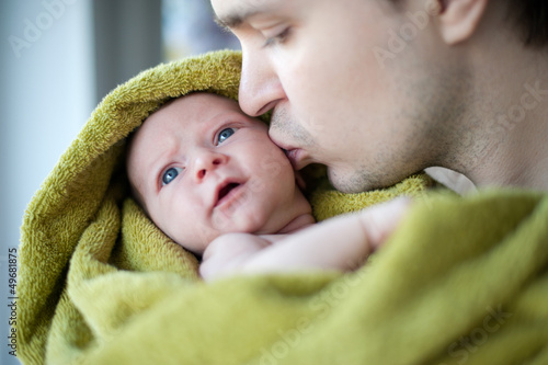 Happy father holding little baby