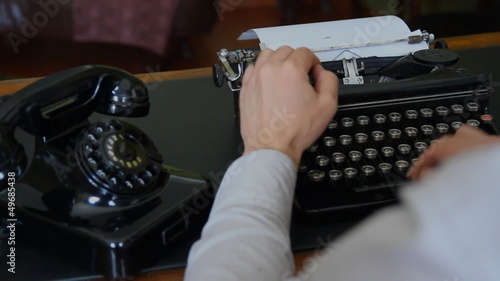 Desk. Vintage typewriter, old phone 