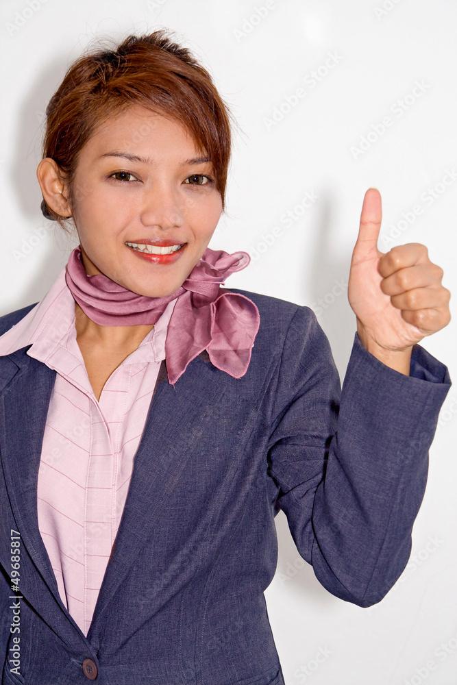 Elegant woman with a thumbs up gesture..