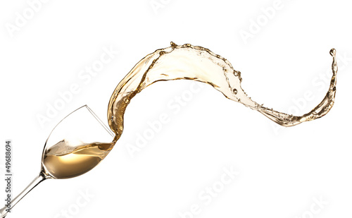 White wine splashing out of glass, isolated on white background