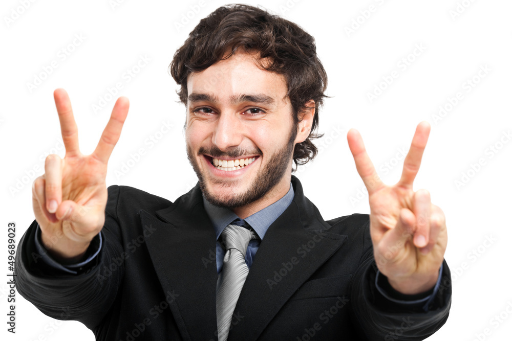 A businessman in a suit giving the victory sign A businessman in a suit giving the victory sign
