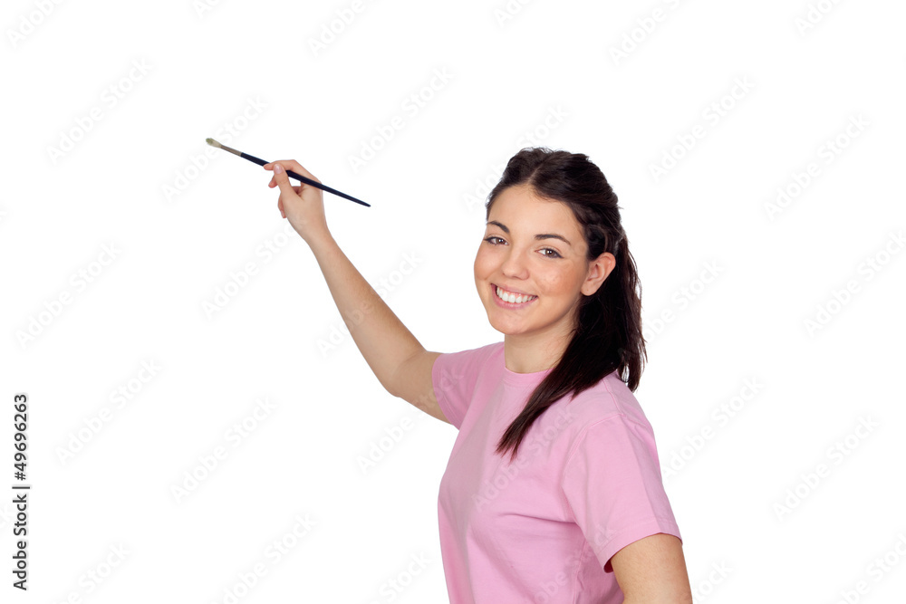 Pretty young girl with a brush painting something Pretty young girl with a brush painting something