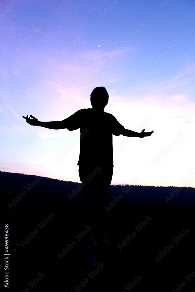 Man standing  at sunset with sky
