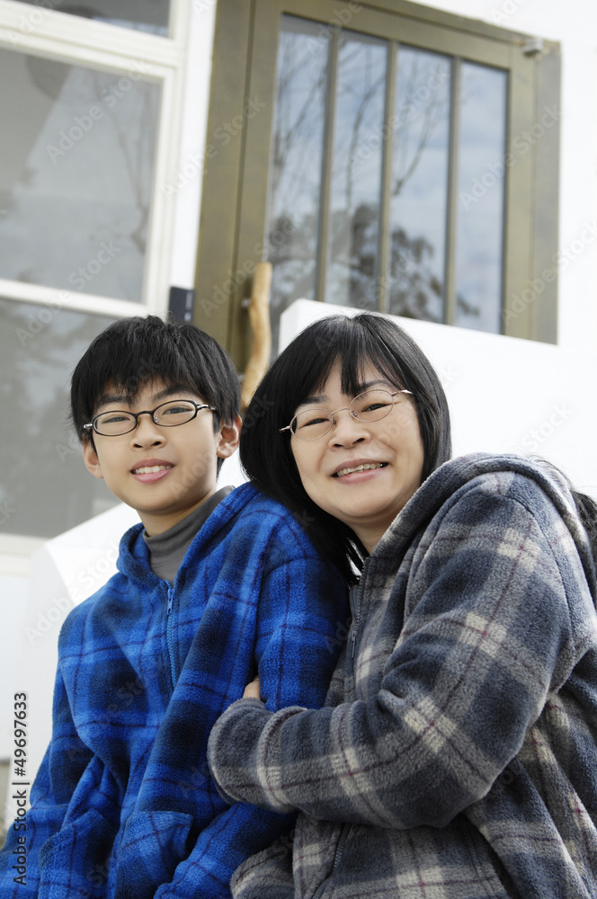 happy mother and son smiling – outdoors house happy mother and son smiling – outdoors house