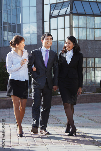 Business people walking and talking in the street.