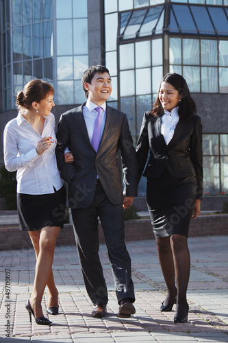 Business people walking and talking in the street.