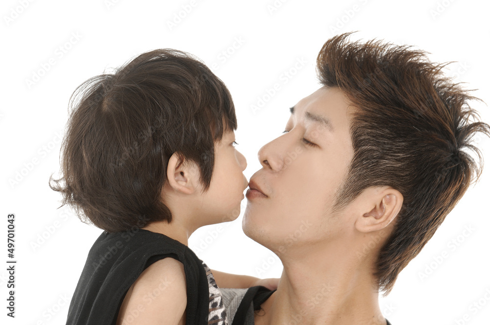 Father kissing his son on the forehead, isolated Father kissing his son on the forehead, isolated
