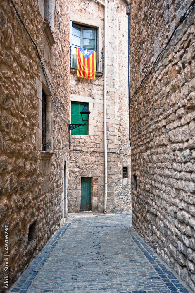 Catalan flags placed on balcony on street in Girona, Spain.