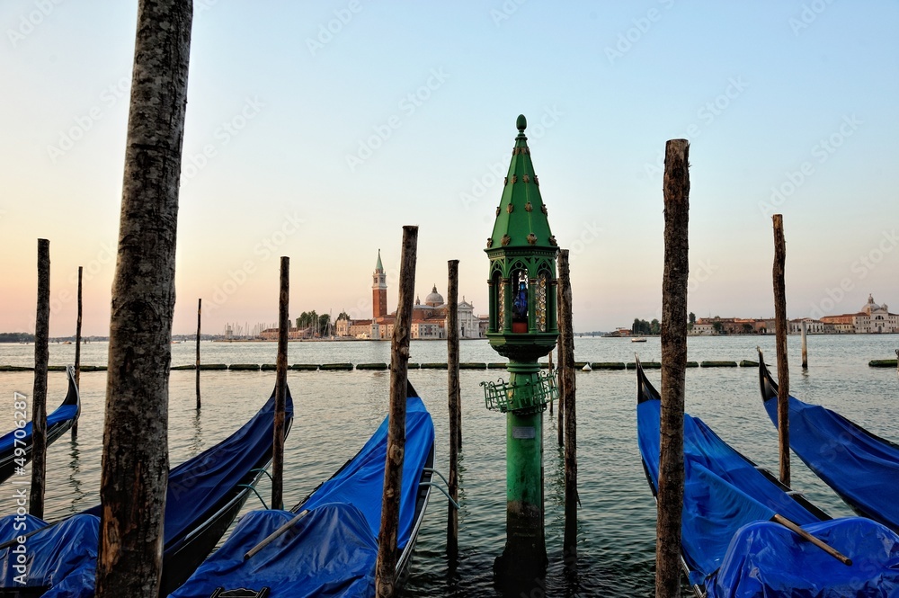 Obraz premium View to the gondolas and boats berth in Venice.