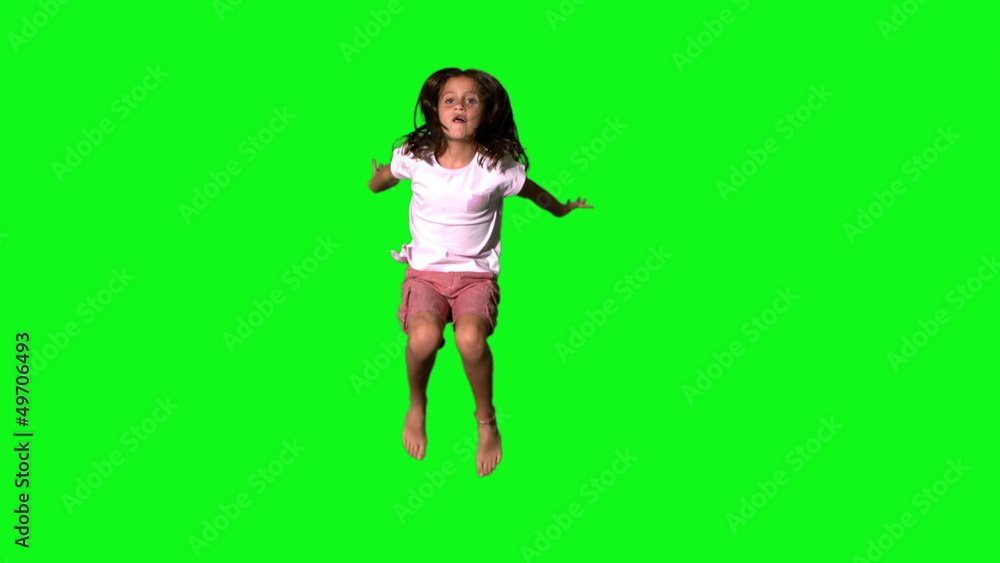 Happy girl jumping on green screen Happy girl jumping on green screen