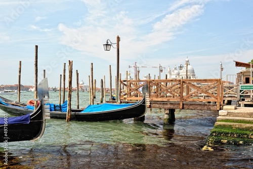 View to the gondolas and boats berth in Venice.