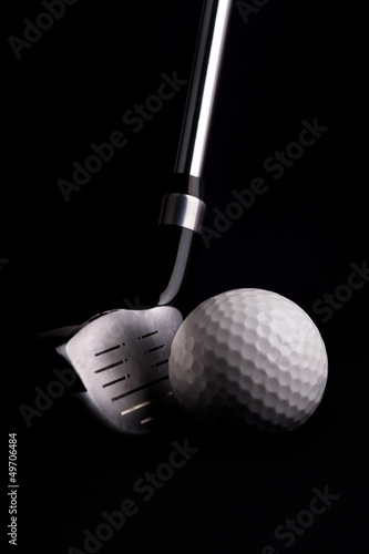 golf club with ball on black background