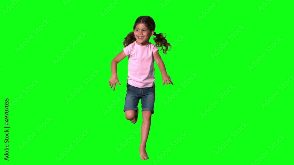 Cute little girl jumping on green screen Cute little girl jumping on green screen