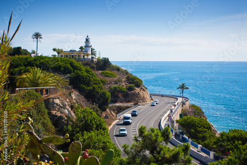 Lighthouse, sea and road near Calella, Spain photo