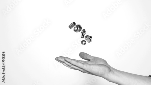 Mans hand throwing screws and bolts photo