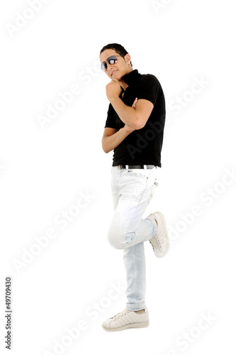 Young teenager standing against the wall isolated