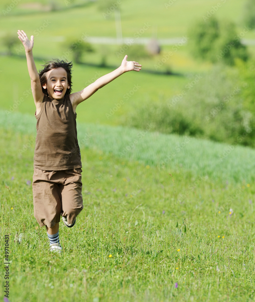 Closeup portrait of a little happy boy outside