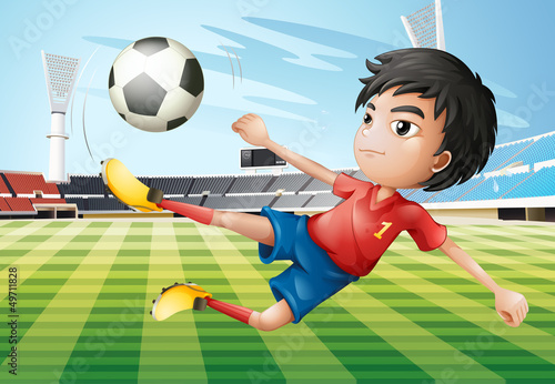 A boy playing soccer at the soccer field