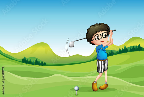 A  boy playing golf