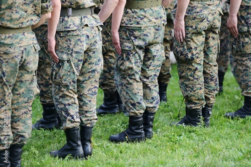 Soldiers with military camouflage uniform in army formation