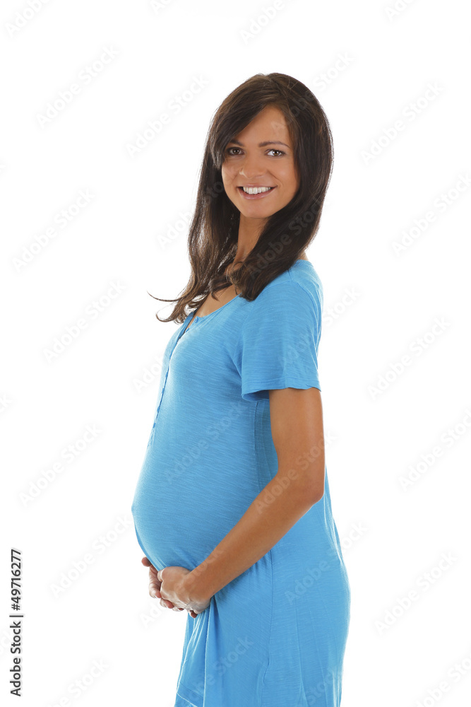 Glückliche schwangere Frau im blauen Kleid hält ihren Bauch Glückliche schwangere Frau im blauen Kleid hält ihren Bauch