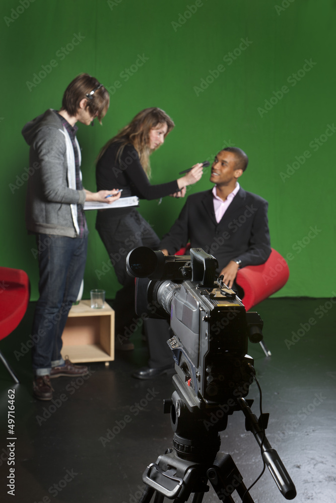 Television camera on tripod in studio Television camera on tripod in studio