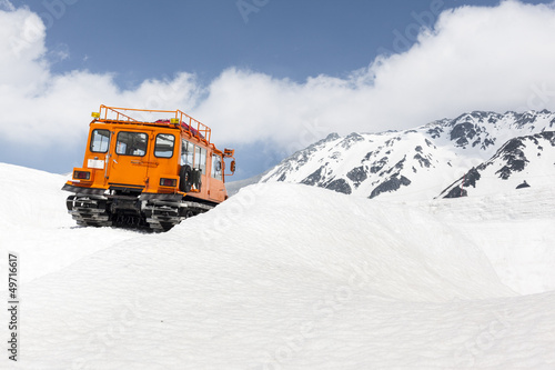 Snow Vehicle in Mountains