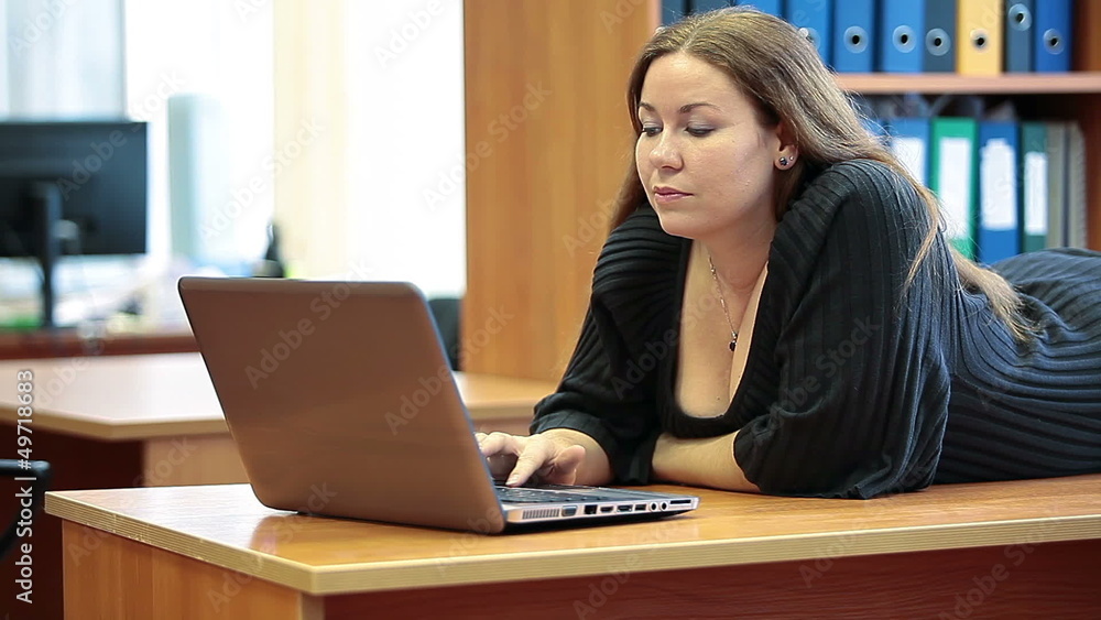 Beautiful woman engrossed while browsing on laptop Beautiful woman engrossed while browsing on laptop