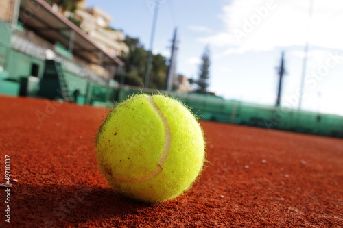 Tennis ball on the clay. © sashka_lenka