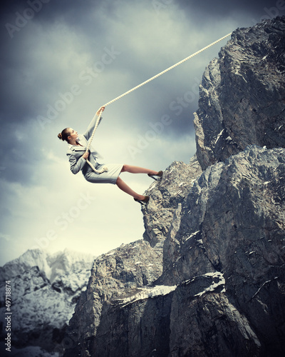 businesswoman climbing mountain